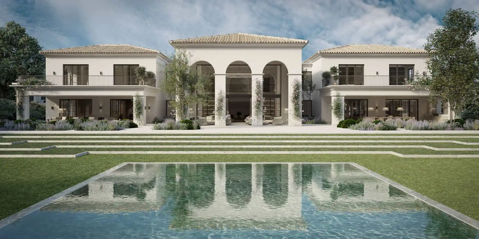 Four Oaks Mediterranean-style luxury villa in La Moraleja by ARK Architects, with elegant arches, a swimming pool, and manicured lawns.