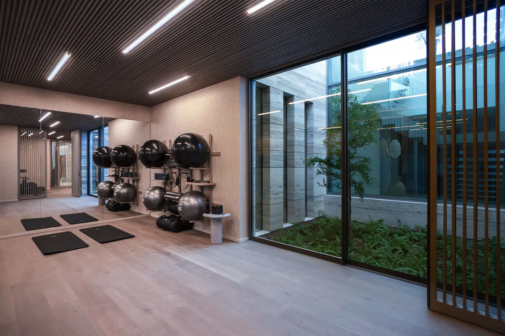 Bespoke home gym with natural light and high-end fitness equipment in a private estate.