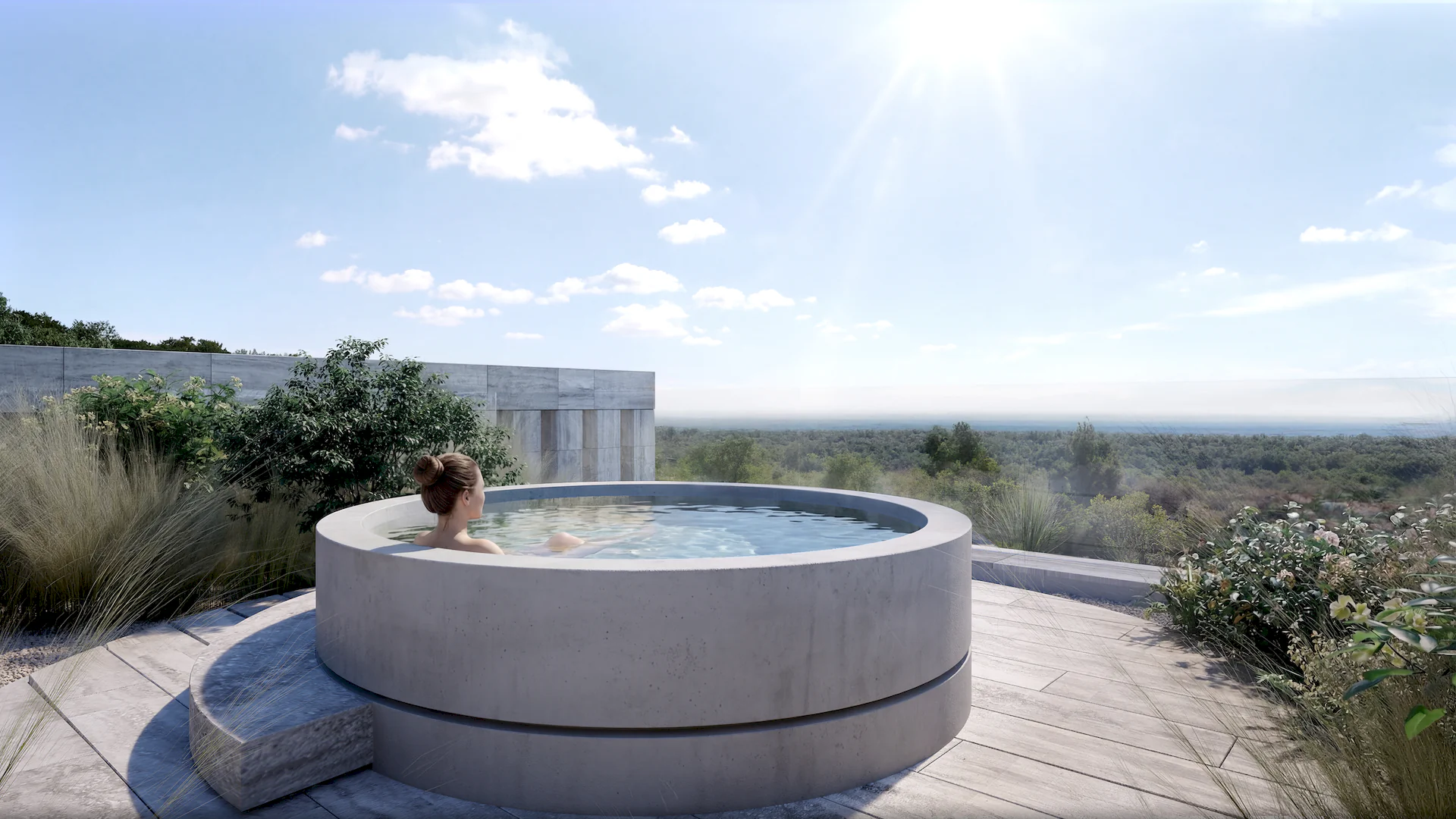 A woman enjoying a jacuzzi in the outdoor garden, overlooking the sea. The NARA Project by Manuel Ruiz ARK Architects